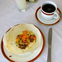 Hopper made from rice flour with egg and herbs added.