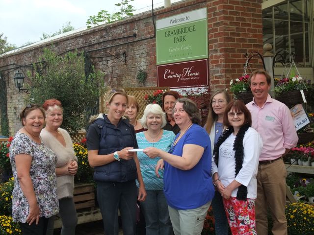 Mrs Sue Potter (in blue) from Brambridge Craft Club presented £350 to Flick from Riding for All.