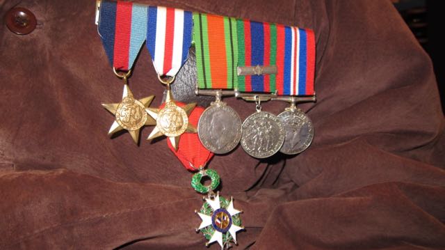 War medals worn by Frank Damerell, including the Legion d'honneur medal (in green and white) awarded by the French government.
