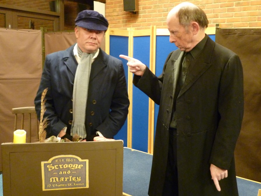 Bob Cratchit (Mike Slatcher) is berated by Ebenezer Scrooge (Lester Parry)