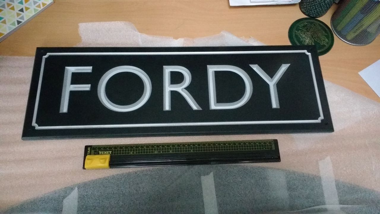 Sign for Fordy, wooden train planter at Chandler's Ford station.