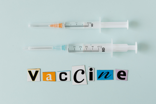 Vaccine background with syringes
